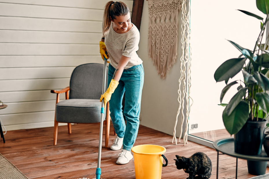 Girl mopping the floor of her house to keep a clean and well-kept environment